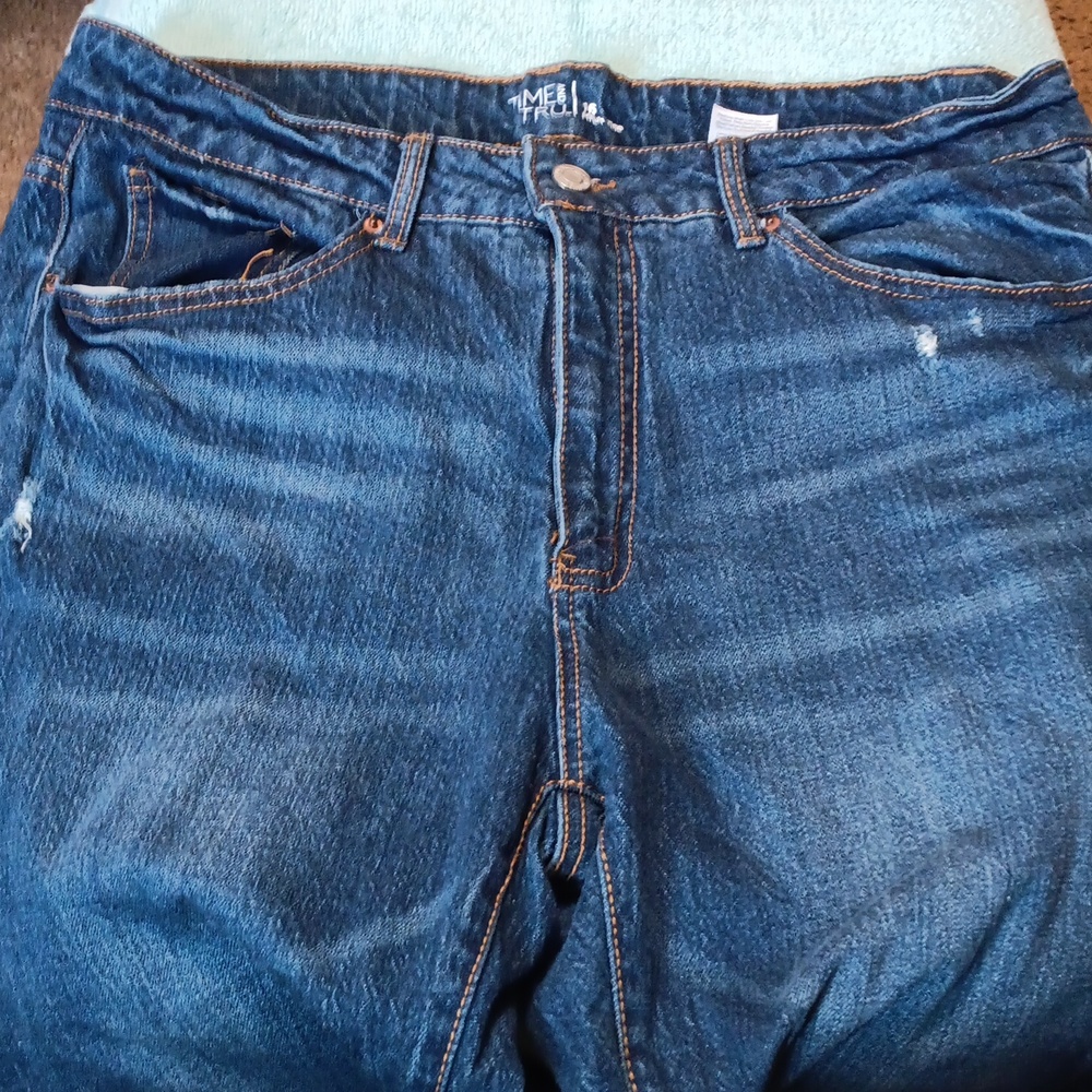 Distressed tatered blue jeans